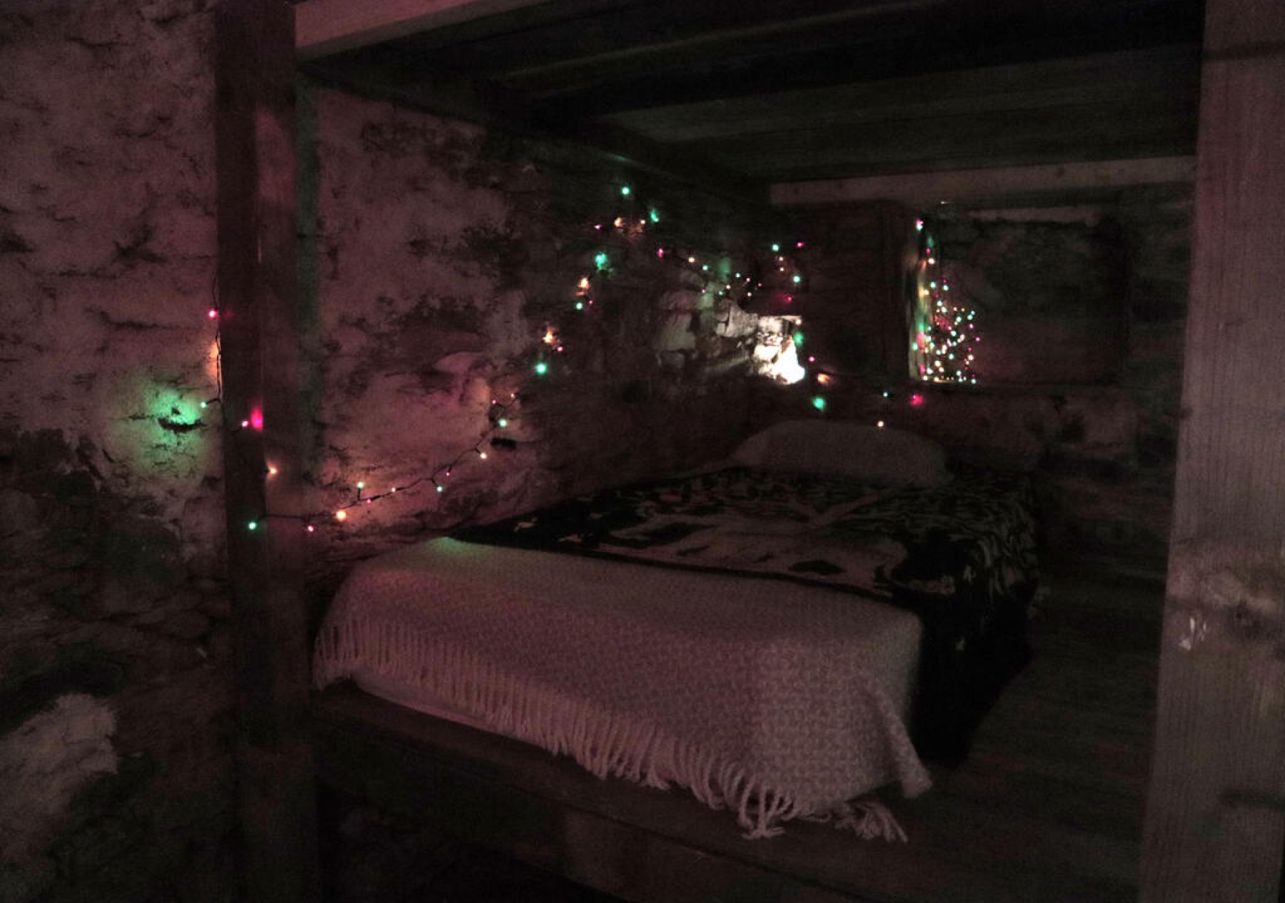 Dorm beds in a stone room